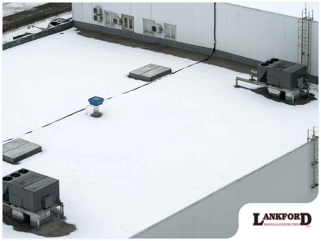 Commercial flat roof showing winter weather and ponding water issues