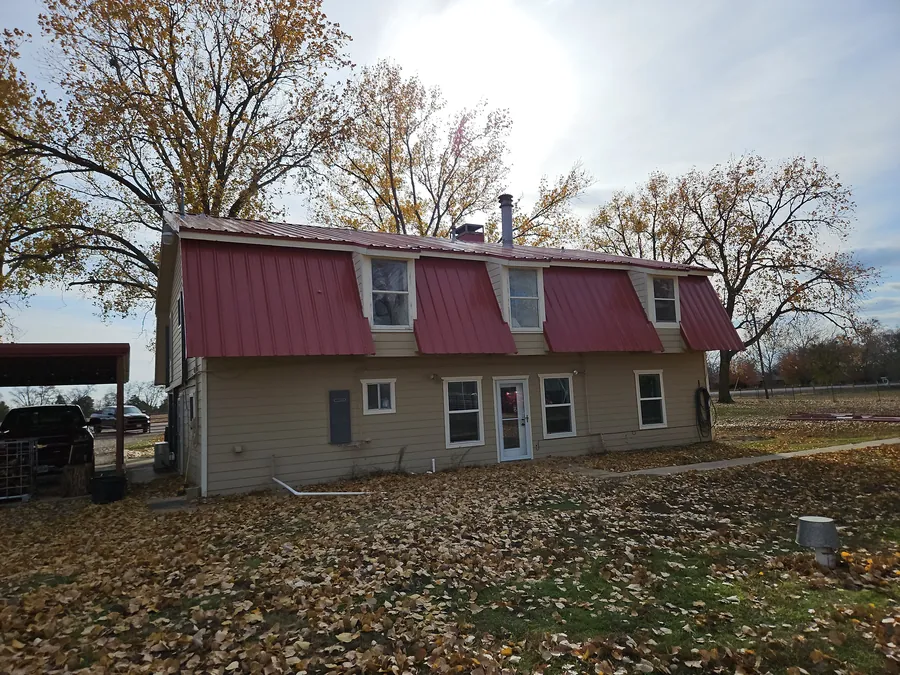 The Blue Ridge house with its new red R-panel metal roof