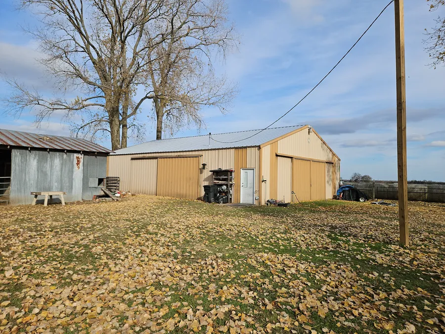 The barn and outbuildings with their new metal roofs