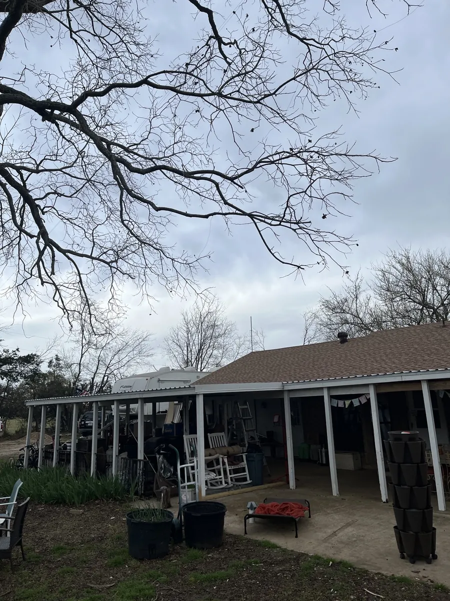 The covered porch with its new white U-panel metal roof