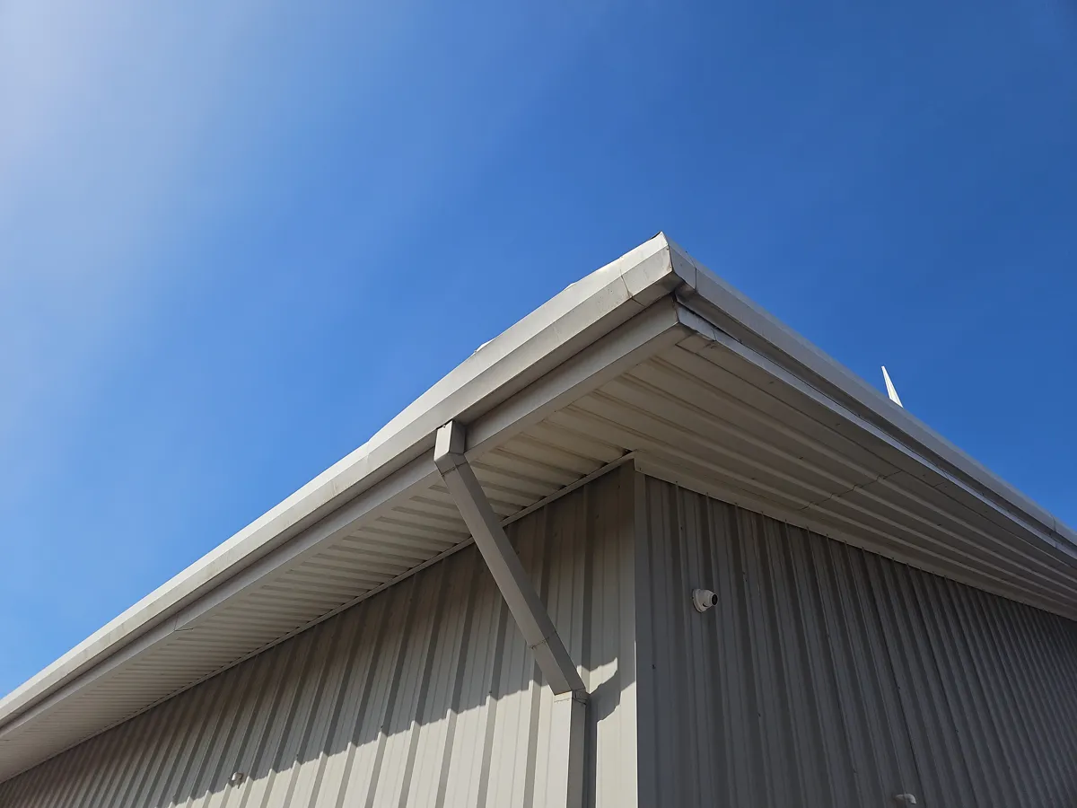 Kingston, OK: new gutter and downspout at a corner of the church building