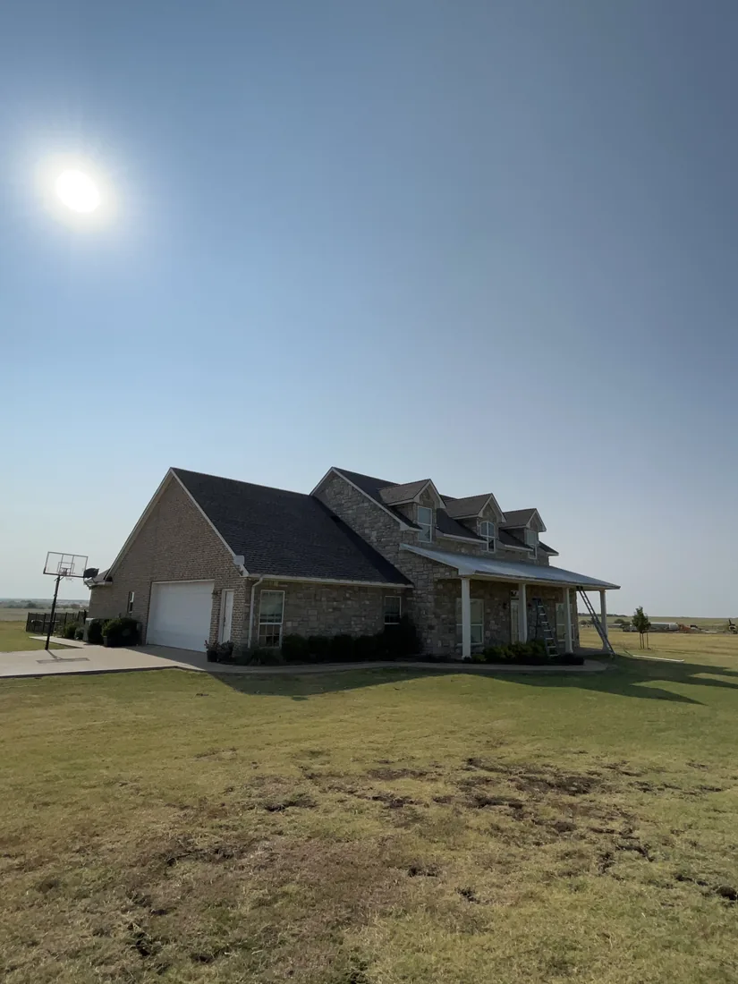 The finished Whitesboro home seen from the front lawn with its new architectural shingle roof